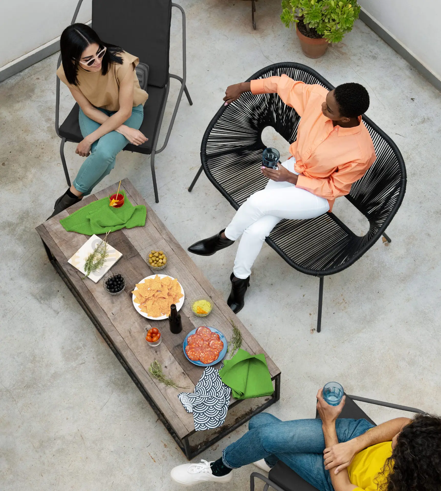Group enjoying snacks and conversation on a modern patio.